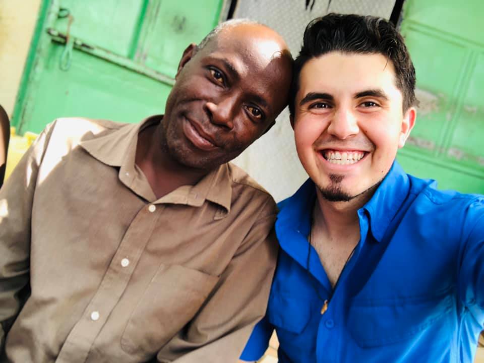Raul smiling next to an older man in a brown shirt