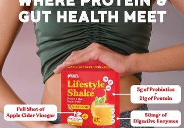 A woman holds a red package of BBFL Lifestyle Shake, with text promoting its protein and gut health benefits, including prebiotics, protein, apple cider vinegar, and digestive enzymes.