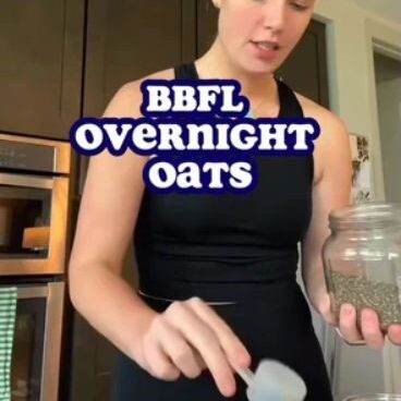 A woman in a black tank top measures ingredients into jars, with text "BBFL OVERNIGHT OATS" overlaid on the image.